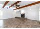 Inviting living room with exposed beams, a ceiling fan, and a tiled fireplace at 1550 W Willow Ave, Phoenix, AZ 85029