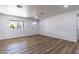 Bright, spacious living room featuring new flooring and a front-facing window at 1550 W Willow Ave, Phoenix, AZ 85029
