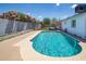 A backyard with a sparkling pool, landscaping and a backyard play area at 1550 W Willow Ave, Phoenix, AZ 85029