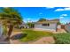 Spacious backyard with a covered patio, desert landscaping, and well-manicured lawn at 1615 E Fremont Dr, Tempe, AZ 85282