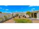 Inviting backyard with a covered patio, desert landscaping, and a green grass patch at 1615 E Fremont Dr, Tempe, AZ 85282