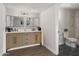 Bright bathroom featuring a dual sink vanity, modern fixtures, and tiled shower at 1615 E Fremont Dr, Tempe, AZ 85282