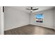 Well-lit bedroom with hardwood floors and a window overlooking the backyard at 1615 E Fremont Dr, Tempe, AZ 85282