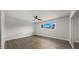 Minimalist bedroom with hardwood floors, ceiling fan, and a window with a neighborhood view at 1615 E Fremont Dr, Tempe, AZ 85282
