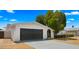 Charming single-story home with a well-manicured front yard and dark grey two-car garage at 1615 E Fremont Dr, Tempe, AZ 85282