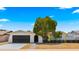 Charming single-story home with a well-manicured front yard and dark grey two-car garage at 1615 E Fremont Dr, Tempe, AZ 85282