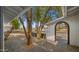 Inviting front porch with brick pavers, mature trees, and an arched entryway to the home at 1615 E Fremont Dr, Tempe, AZ 85282