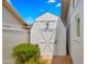Exterior of a white wooden shed with a double door and secure latch at 1615 E Fremont Dr, Tempe, AZ 85282