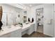 Sleek bathroom featuring dual vanities, a glass-enclosed shower, and a convenient walk-in closet at 17383 W Fallen Leaf Ln, Surprise, AZ 85387