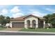 Charming single-story home featuring a tile roof, attached two-car garage, and beautifully landscaped front yard at 17383 W Fallen Leaf Ln, Surprise, AZ 85387