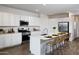 Modern kitchen with stainless steel appliances, ample counter space, and a breakfast bar for casual dining at 17383 W Fallen Leaf Ln, Surprise, AZ 85387