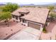 Aerial shot of a desert home with a tile roof, well-kept landscaping, and a front-facing garage at 18 E Paint Your Wagon Trl, Phoenix, AZ 85085