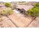 Backyard view showcasing a covered patio area with desert landscape at 18 E Paint Your Wagon Trl, Phoenix, AZ 85085