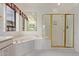 Bright bathroom features a soaking tub, glass enclosed shower, and large mirror at 18 E Paint Your Wagon Trl, Phoenix, AZ 85085