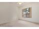 Neutral carpeted bedroom with a large window providing natural light and outdoor views at 18 E Paint Your Wagon Trl, Phoenix, AZ 85085