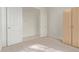 Neutral carpeted bedroom featuring a built-in wardrobe and an open doorway to another space at 18 E Paint Your Wagon Trl, Phoenix, AZ 85085