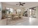 Dining area featuring a rustic wooden table, large windows, and sliding glass doors for indoor/outdoor living at 18 E Paint Your Wagon Trl, Phoenix, AZ 85085