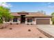 Inviting single-story home with a desert landscape, tiled roof, and a warm, neutral color palette at 18 E Paint Your Wagon Trl, Phoenix, AZ 85085