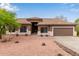 Inviting single-story home with a desert landscape, tiled roof, and a warm, neutral color palette at 18 E Paint Your Wagon Trl, Phoenix, AZ 85085