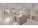 Eat-in kitchen featuring an island with breakfast bar seating, a neutral color palette, and an adjacent sitting area at 18 E Paint Your Wagon Trl, Phoenix, AZ 85085
