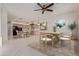 Open kitchen and dining area with light wood cabinets, a breakfast bar, and tile flooring throughout at 18 E Paint Your Wagon Trl, Phoenix, AZ 85085