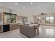 Eat-in kitchen featuring an island with breakfast bar seating, black appliances, and light wood cabinetry at 18 E Paint Your Wagon Trl, Phoenix, AZ 85085