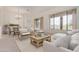 Bright living room with large windows, comfortable seating, and elegant chandelier, creating a relaxing atmosphere at 18 E Paint Your Wagon Trl, Phoenix, AZ 85085