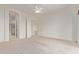 Spacious main bedroom features plush carpeting, white walls, a ceiling fan, and access to the main bathroom at 18 E Paint Your Wagon Trl, Phoenix, AZ 85085