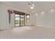 Expansive main bedroom featuring plush carpeting, white walls, ceiling fan and sliding glass door access to a balcony at 18 E Paint Your Wagon Trl, Phoenix, AZ 85085