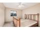 A sun-lit bedroom features a ceiling fan and large windows at 1857 S El Marino Cir, Mesa, AZ 85202