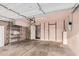 Spacious garage with storage shelves, multiple doors, and overhead lighting at 1857 S El Marino Cir, Mesa, AZ 85202