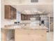 Kitchen features laminated countertops, light cabinets, a stainless steel refrigerator, and white appliances at 1857 S El Marino Cir, Mesa, AZ 85202
