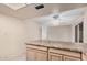 Kitchen features laminated countertops, light cabinets, tile flooring, with access to dining area at 1857 S El Marino Cir, Mesa, AZ 85202