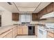 Kitchen features laminated countertops, dark cabinets, a stainless steel refrigerator, and white appliances at 1857 S El Marino Cir, Mesa, AZ 85202