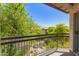 Relaxing balcony with wrought iron railing overlooking lush landscaping and neighborhood views at 2019 E Campbell Ave # 110, Phoenix, AZ 85016