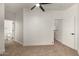 A simple bedroom with carpet flooring, two door access points, and a modern ceiling fan at 2019 E Campbell Ave # 110, Phoenix, AZ 85016
