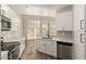 Bright kitchen with white cabinets, stainless steel appliances, and a view to the outdoors at 2019 E Campbell Ave # 110, Phoenix, AZ 85016