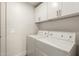 Convenient laundry room with a washing machine, dryer, and overhead storage cabinets at 2019 E Campbell Ave # 110, Phoenix, AZ 85016