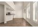 Living room featuring wood laminate floors and expansive window features with shutter at 2019 E Campbell Ave # 110, Phoenix, AZ 85016