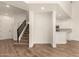 Open floor plan with living room, kitchen and stairs featuring wood laminate floors at 2019 E Campbell Ave # 110, Phoenix, AZ 85016