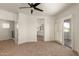 Spacious main bedroom featuring a ceiling fan, sliding glass doors, and doorway to the main bathroom at 2019 E Campbell Ave # 110, Phoenix, AZ 85016