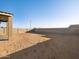 Expansive, level backyard with a block wall and a covered patio area at 20319 N 224Th Dr, Surprise, AZ 85387