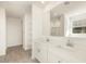 Bright bathroom featuring double sinks, large mirror, and tile flooring at 20319 N 224Th Dr, Surprise, AZ 85387