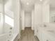 Bright bathroom featuring double sinks, white cabinets, and tile flooring at 20319 N 224Th Dr, Surprise, AZ 85387