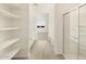 Well-lit bathroom featuring tiled floors, shower, and built in shelving at 20319 N 224Th Dr, Surprise, AZ 85387