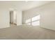 Bright, neutral bedroom featuring plush carpet and an ensuite bathroom entrance at 20319 N 224Th Dr, Surprise, AZ 85387