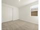 Bright bedroom featuring a window and a sliding door closet at 20319 N 224Th Dr, Surprise, AZ 85387