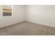 Simple bedroom with neutral walls and carpet, featuring a window with blinds at 20319 N 224Th Dr, Surprise, AZ 85387