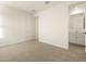 Bright bedroom featuring a door, window and access to the bathroom at 20319 N 224Th Dr, Surprise, AZ 85387