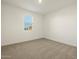 Bright bedroom featuring neutral carpet and a window with blinds at 20319 N 224Th Dr, Surprise, AZ 85387